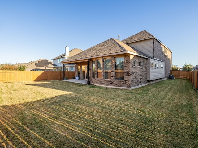 back of property featuring a patio area, central air condition unit, and a lawn