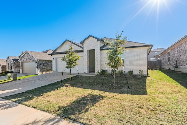 view of front of house with a front yard and a garage