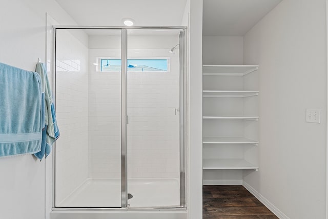 bathroom featuring hardwood / wood-style floors and an enclosed shower