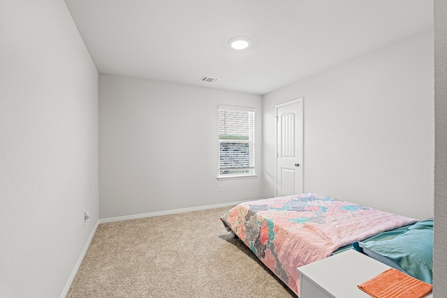 bedroom featuring light colored carpet