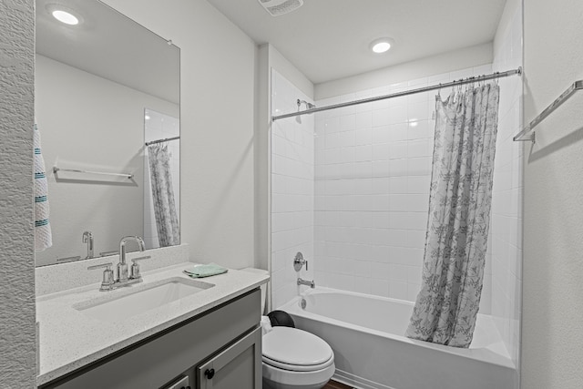 full bathroom with vanity, shower / bath combination with curtain, and toilet