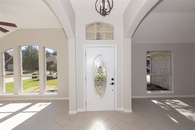 foyer entrance featuring ceiling fan and lofted ceiling