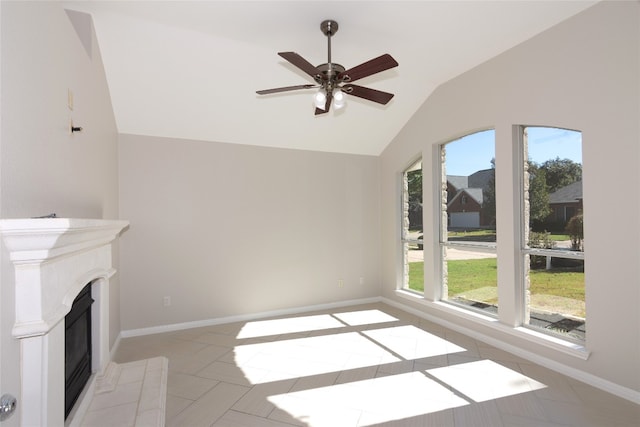 unfurnished living room featuring ceiling fan, lofted ceiling, light tile patterned floors, and a tiled fireplace