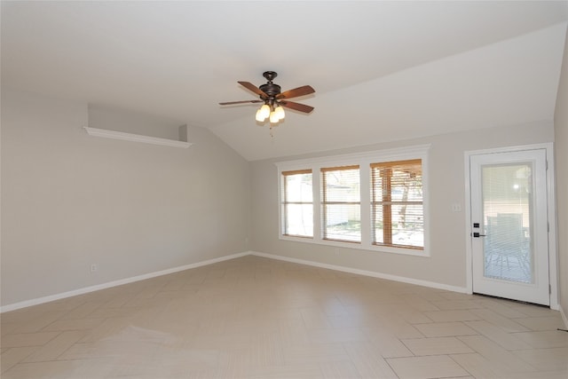 empty room with ceiling fan and vaulted ceiling