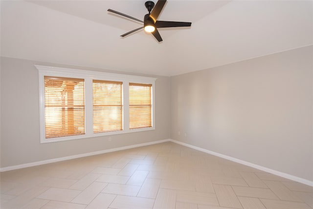 spare room featuring vaulted ceiling and ceiling fan