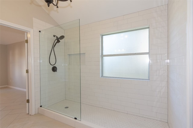 bathroom featuring tile patterned flooring and a tile shower