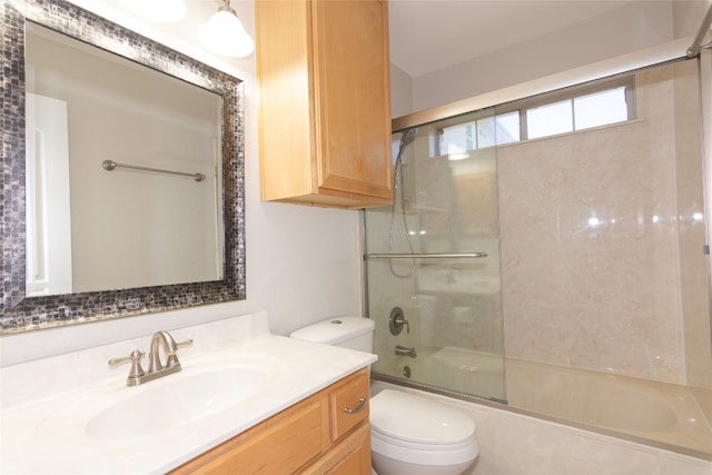 full bathroom featuring shower / bath combination with glass door, vanity, and toilet