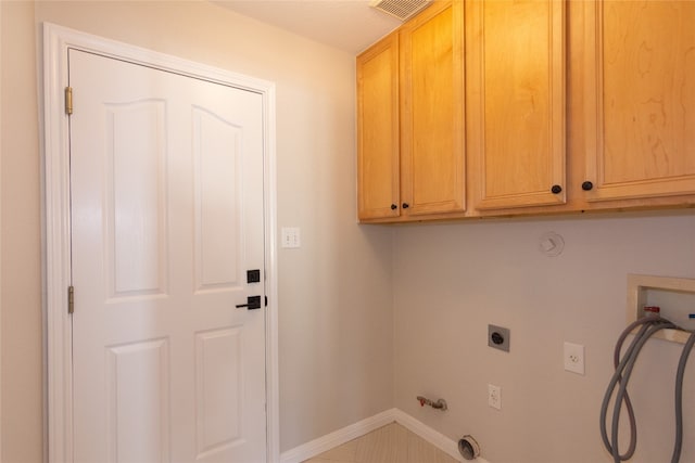 washroom featuring gas dryer hookup, hookup for a washing machine, cabinets, and hookup for an electric dryer