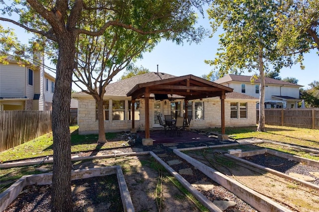 1709 Todd Ln, Cedar Park, TX 78613 - back of property with a garden, a patio, stone siding, and a fenced backyard