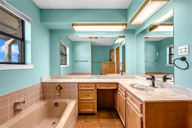 bathroom featuring a washtub and vanity