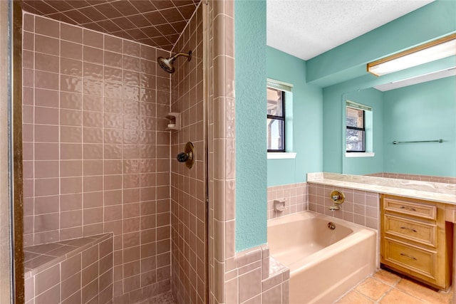 bathroom with tile patterned flooring, a textured ceiling, and independent shower and bath