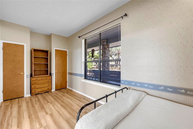 bedroom featuring hardwood / wood-style floors and a textured ceiling