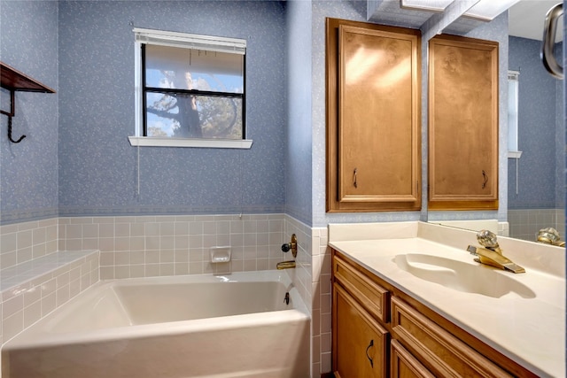 bathroom with a tub to relax in and vanity