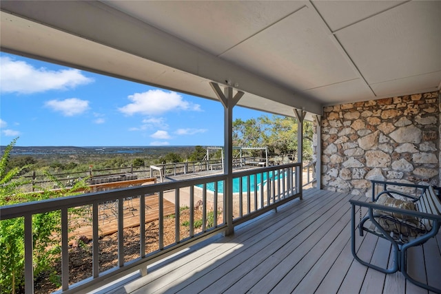 wooden deck with a fenced in pool