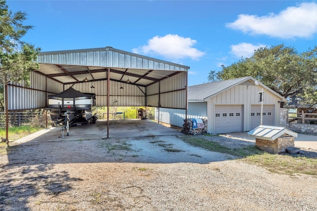 view of parking / parking lot featuring a carport and a garage