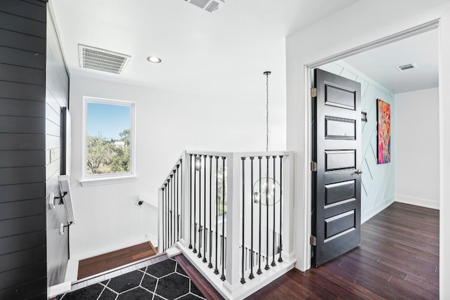 corridor with dark hardwood / wood-style flooring