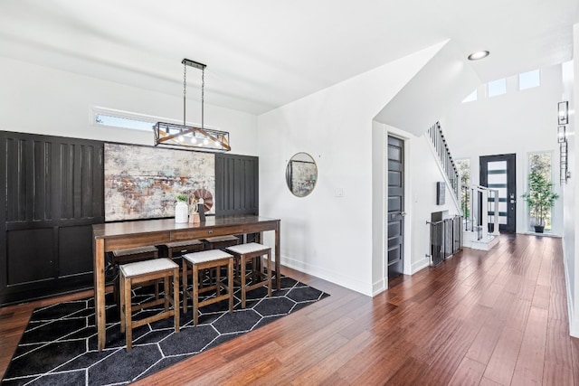 dining area with dark hardwood / wood-style floors and a chandelier