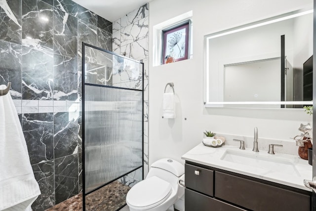 bathroom featuring tiled shower, vanity, and toilet