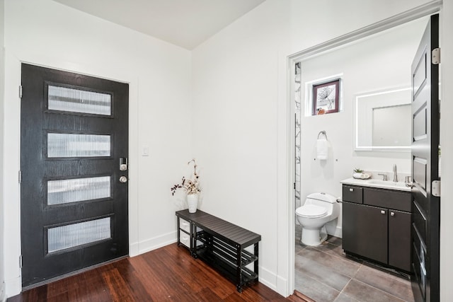 entryway with dark hardwood / wood-style flooring and sink