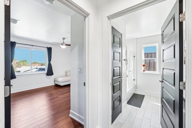 bathroom with hardwood / wood-style flooring and ceiling fan