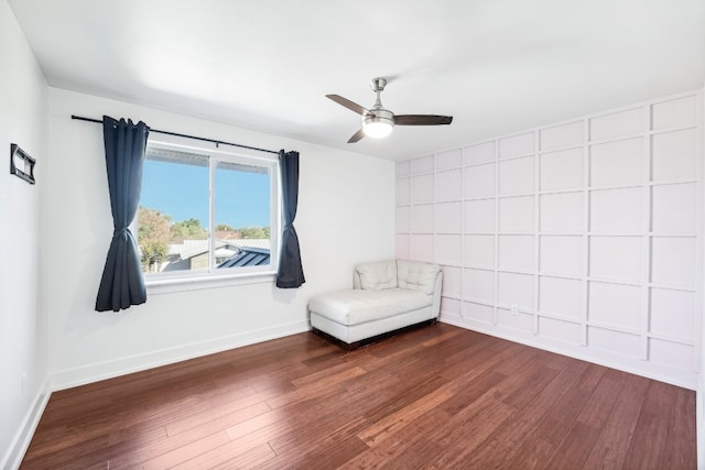 unfurnished room with dark wood-type flooring and ceiling fan