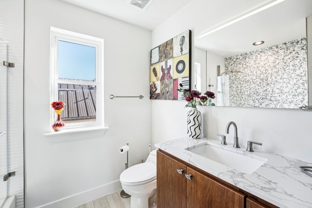 bathroom featuring vanity, toilet, and a shower with shower curtain