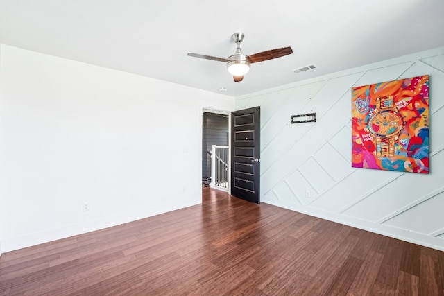 empty room featuring dark wood-type flooring and ceiling fan