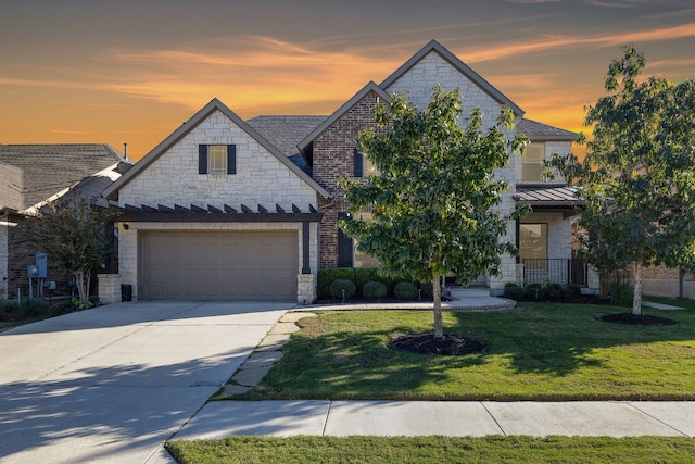 view of front of house featuring a lawn and a garage