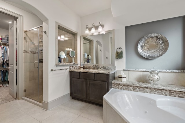 bathroom with tile patterned flooring, vanity, and independent shower and bath