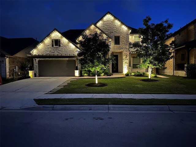 view of front of house with a yard and a garage