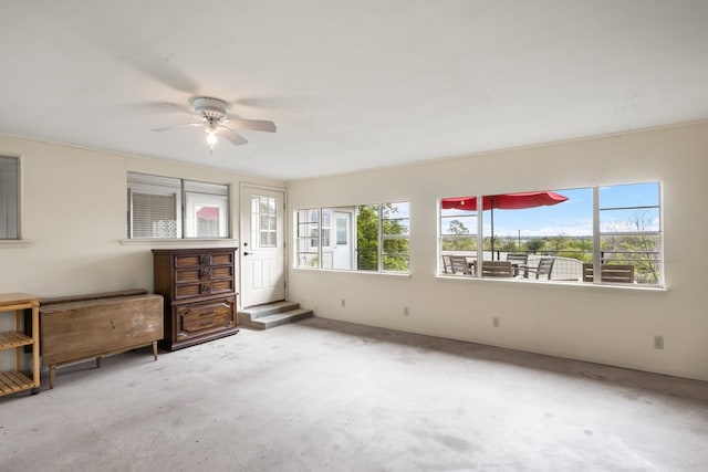 interior space with ceiling fan