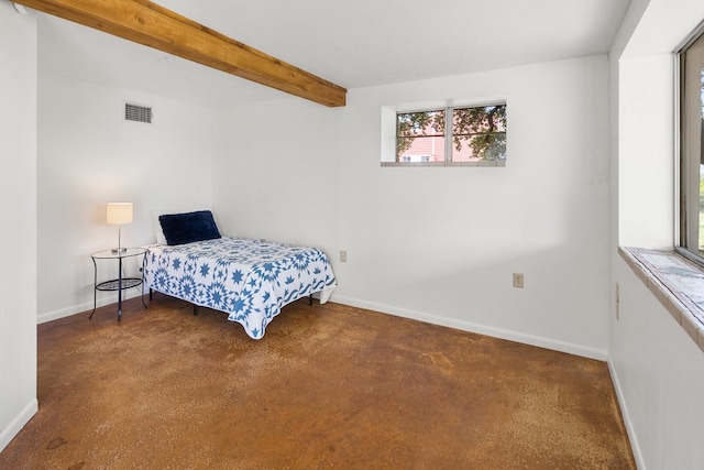 bedroom featuring beam ceiling and dark carpet