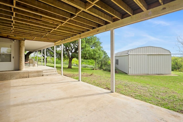 view of patio featuring an outbuilding