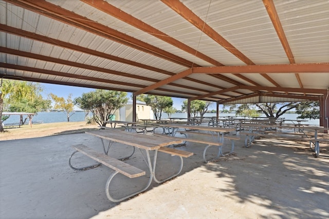 view of home's community featuring a water view and an outdoor structure