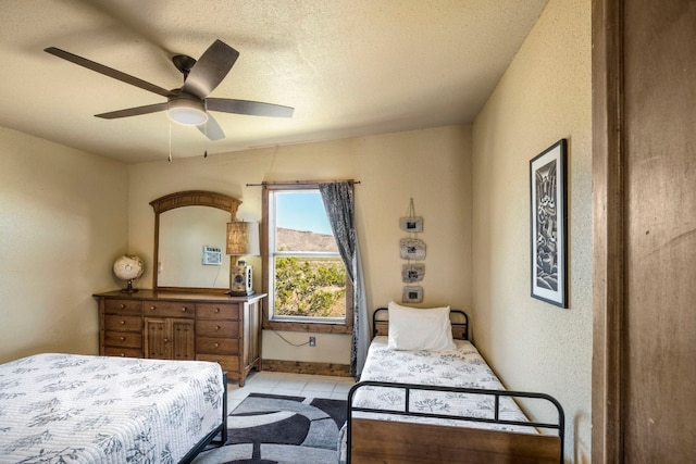 9301 Terlingua Ranch Rd Unit 8025, Alpine, TX 79852 - tiled bedroom with ceiling fan and a textured ceiling