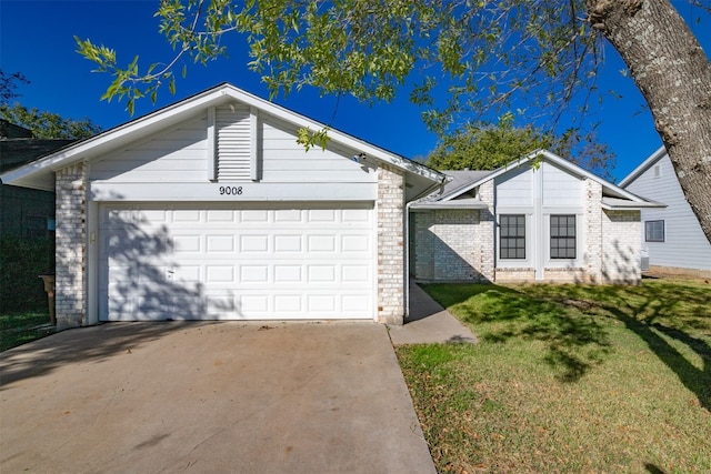 ranch-style house featuring a garage and a front lawn