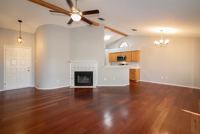 unfurnished living room featuring lofted ceiling with beams, a fireplace, dark wood-type flooring, and ceiling fan with notable chandelier