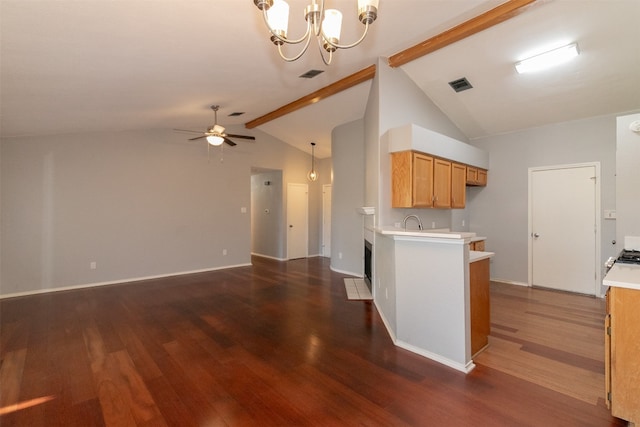 kitchen with pendant lighting, lofted ceiling with beams, dark hardwood / wood-style flooring, and ceiling fan with notable chandelier