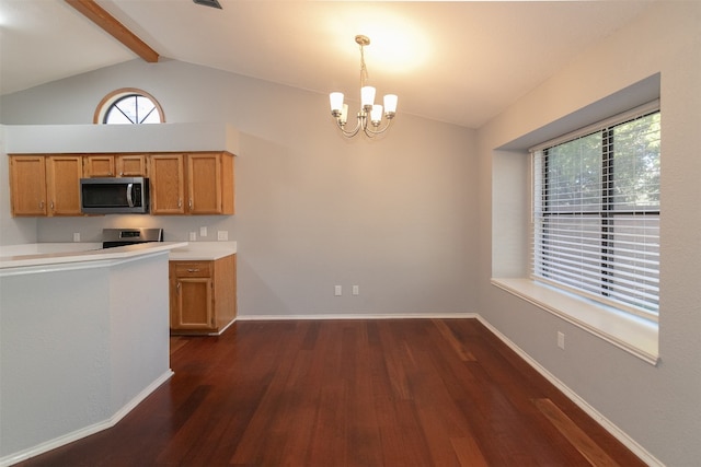 kitchen featuring pendant lighting, dark wood-type flooring, a wealth of natural light, and a chandelier