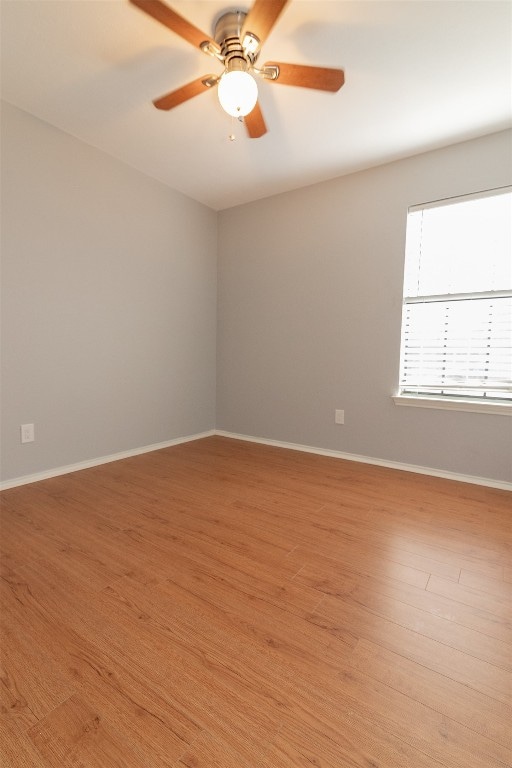 spare room featuring light hardwood / wood-style floors and ceiling fan