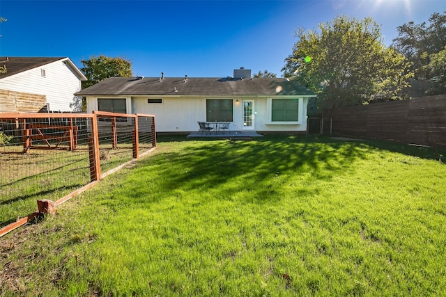 back of property featuring central AC and a yard