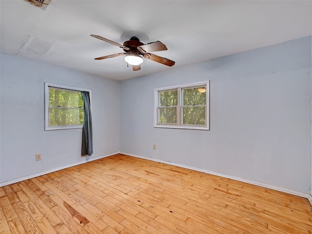 empty room featuring ceiling fan and light wood-type flooring