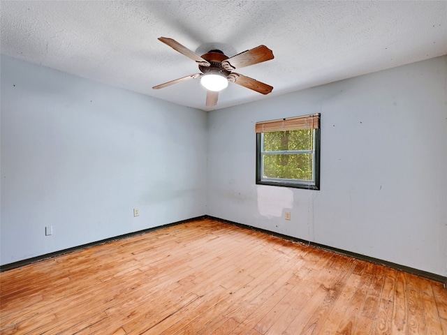 spare room with a textured ceiling, light hardwood / wood-style flooring, and ceiling fan