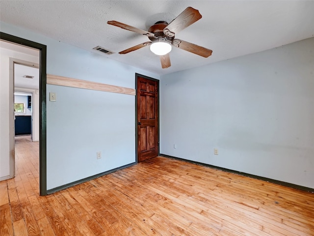 unfurnished bedroom with ceiling fan, light hardwood / wood-style flooring, and a textured ceiling