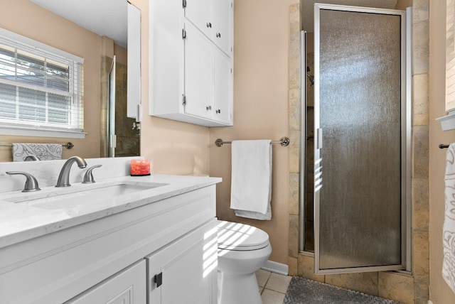 bathroom with toilet, vanity, tile patterned floors, and a shower with shower door