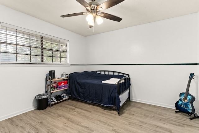 bedroom with ceiling fan and wood-type flooring