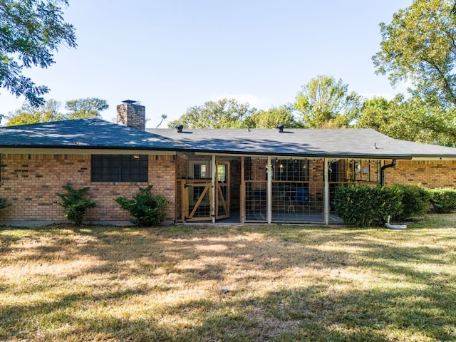 back of property featuring a lawn and a patio area