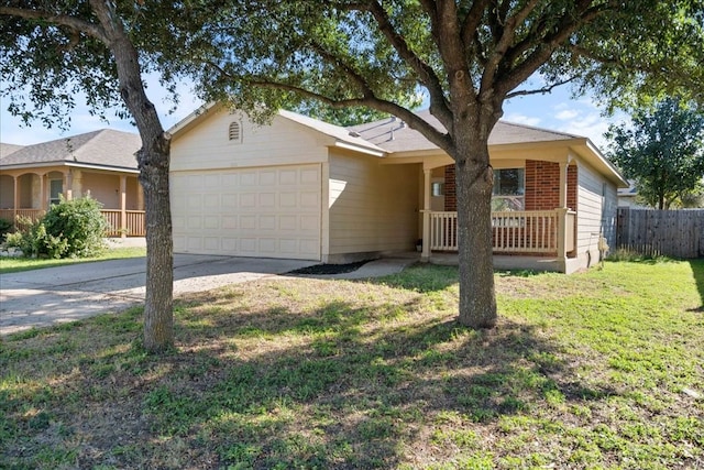 ranch-style house featuring covered porch, a garage, and a front lawn