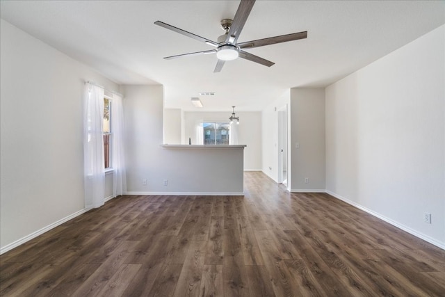 unfurnished living room with ceiling fan and dark hardwood / wood-style flooring