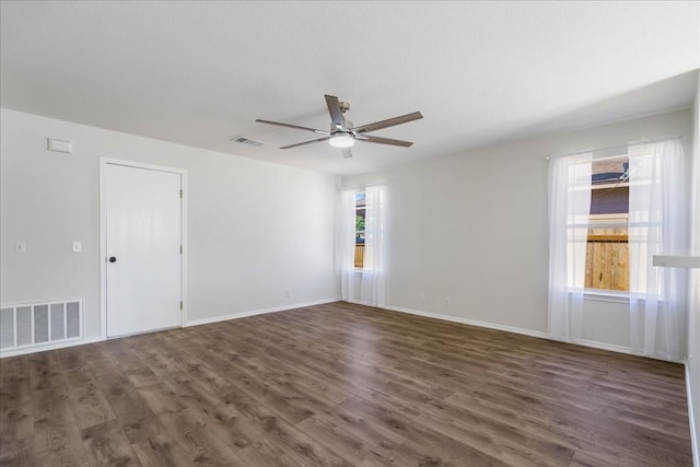 unfurnished room with dark hardwood / wood-style floors and ceiling fan